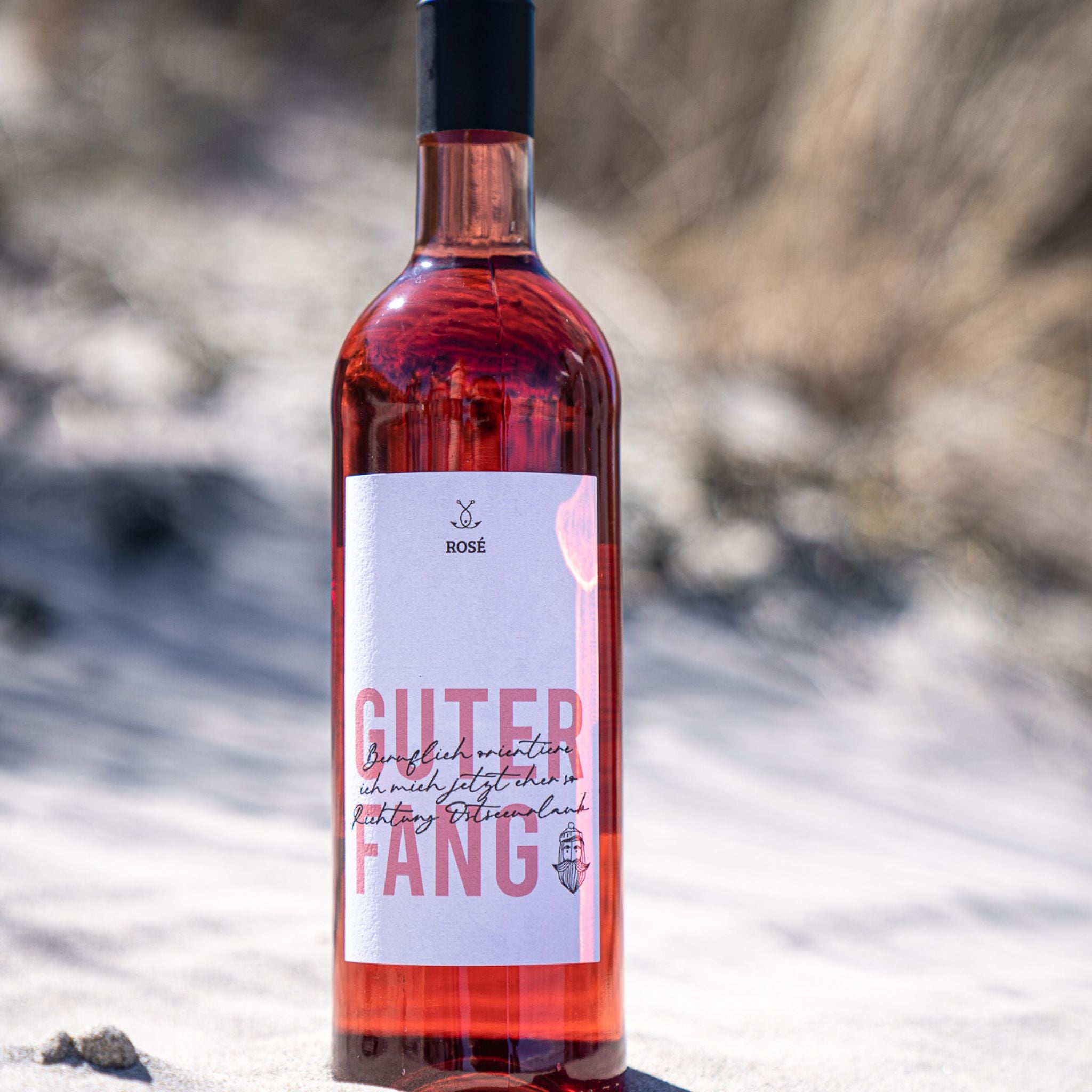 Detailaufnahme Guter Fang Rosé Flasche im Sand