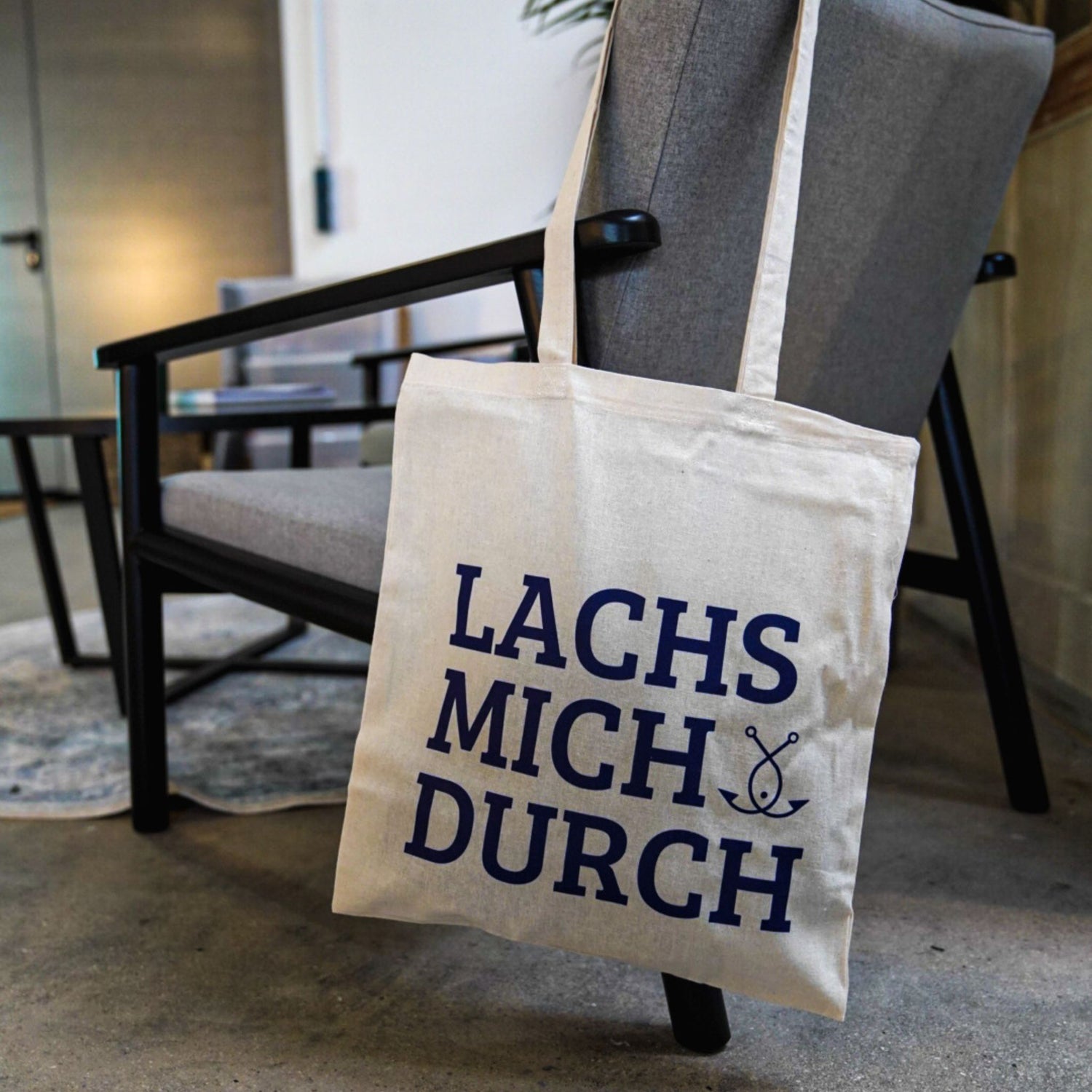 Jutebeutel mit Aufdruck LACHS MICH DURCH an Sessel – Fangfrisch